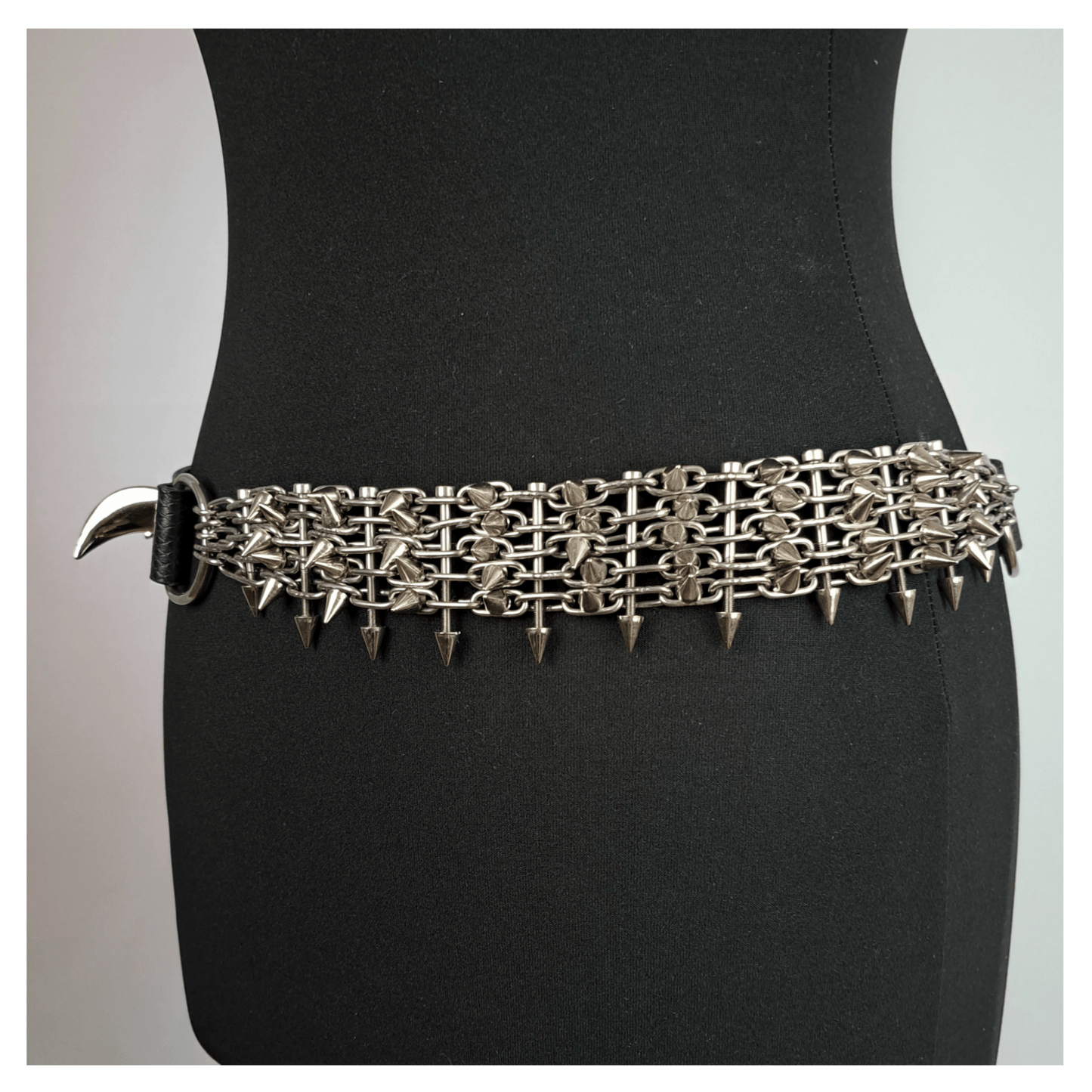 KLINGENSÄNGER — VIPER edition belt left side view on black mannequin, featuring black viper print leather, metal chainspike hardware, and fang studs — gothic handcrafted accessory by skinpressedtight