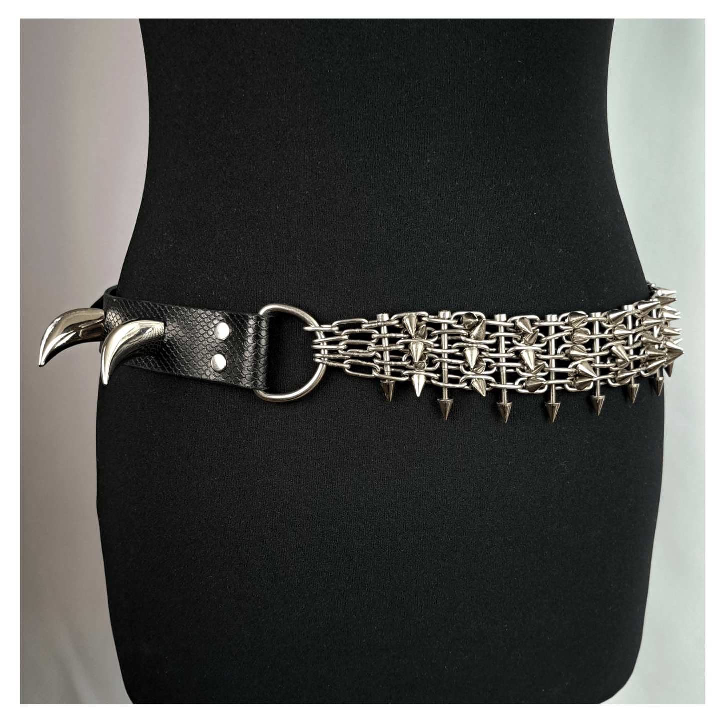 KLINGENSÄNGER — VIPER edition belt with black viper print leather and metal chainspike hardware, featuring two large fang studs on mannequin — edgy gothic statement piece by skinpressedtight