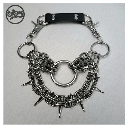 ChatGPT said:

FEGEFLAMME brutalist necklace laid out on a white background, front view showing studded stainless steel chains with small zinc alloy claw spikes, central O-ring, and reclaimed leather neckpiece secured with stainless steel carbines — gothic handcrafted accessory by skinpressedtight.