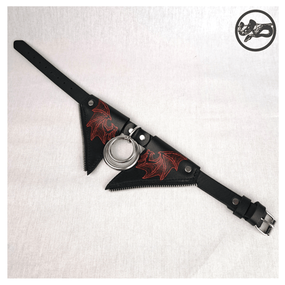 FLEDERTIER – SABBATH choker necklace laid out opened up on a white background, showing the front view of the black leather design with stainless steel and zinc alloy hardware and striking handpainted red bat wing ornaments, by skinpressedtight.