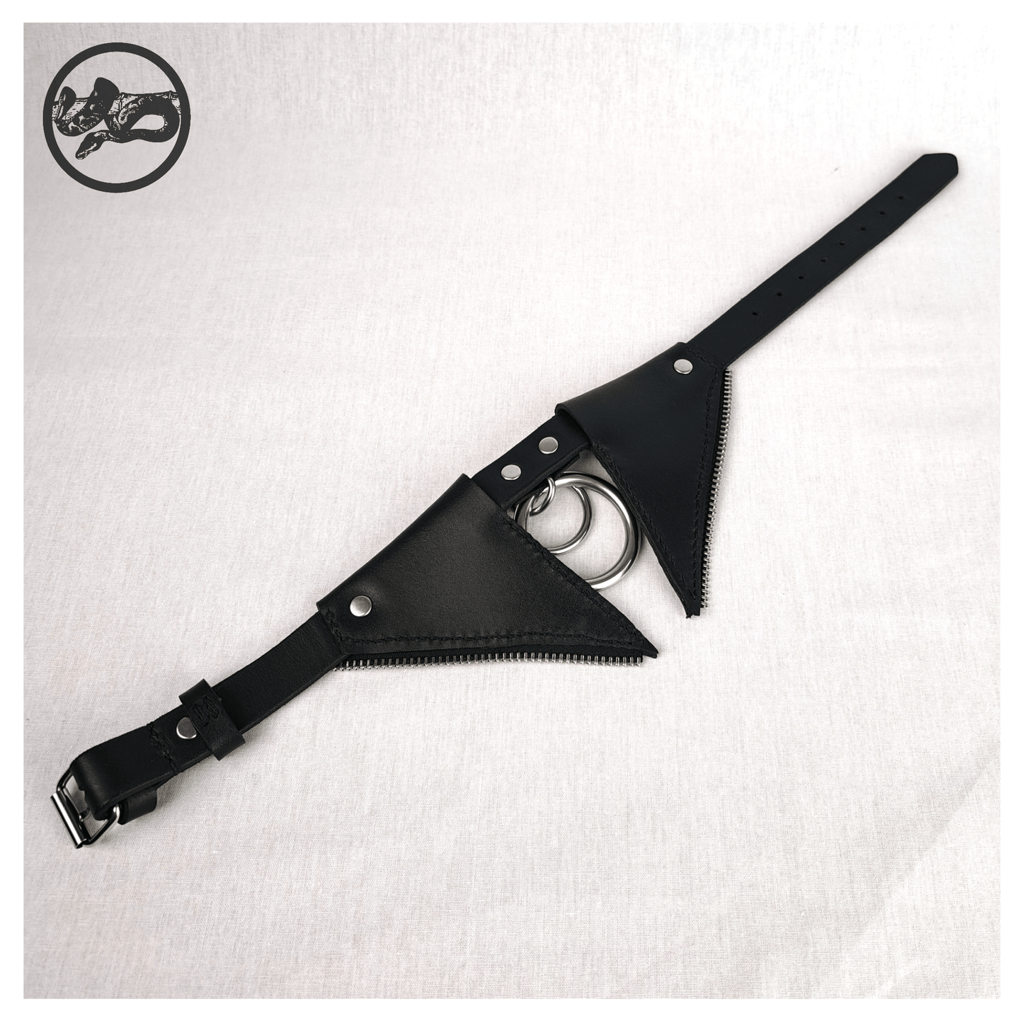 FLEDERTIER – SABBATH choker necklace laid out opened up on a white background, showing the back view of black leather with stainless steel and zinc alloy hardware and handpainted red bat wing ornaments, by skinpressedtight.