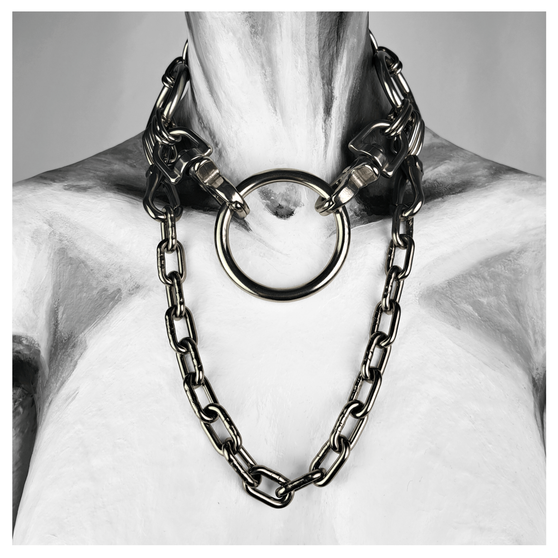 FROSTGLANZ brutalist necklace featuring central stainless steel ring held by two carabiners, flanked by a detachable chain and finished with a reclaimed leather neckpiece — shown on mannequin, handcrafted by skinpressedtight