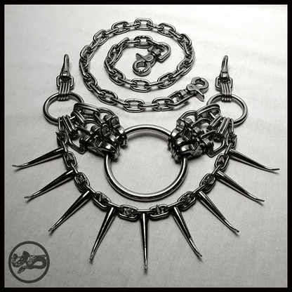 MYRAPOD - SPINNENLÄUFER belt in brutalist design with spiked chain, handcrafted from stainless steel. This edition is extended with a chunky chain, spiked with huge zinc alloys claw studs — shown shown laid out on table, alternative statement piece by skinpressedtight