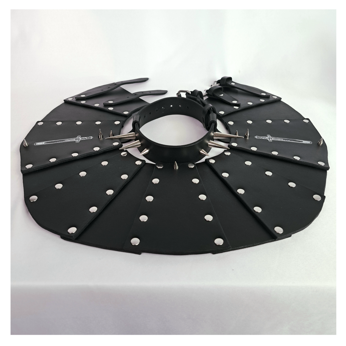 BLUTSPUR leather gorget laid out open: the fan of riveted black leather panels and the spiked neck strap. Handmade by skinpressedtight