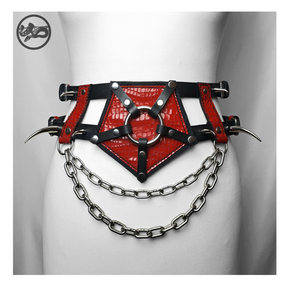 PURGATORIUM – DĀMONROT harness belt on a white dress form, front: glossy red leather pentagram around a stainless ring, curved spikes and two swags of chain. Handmade by skinpressedtight