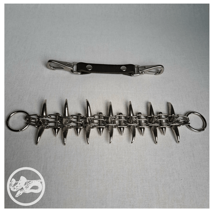 QUERULANT choker necklace made of reclaimed leather and metal hardware, displayed opened up from the front on table — edgy, handcrafted gothic accessory.