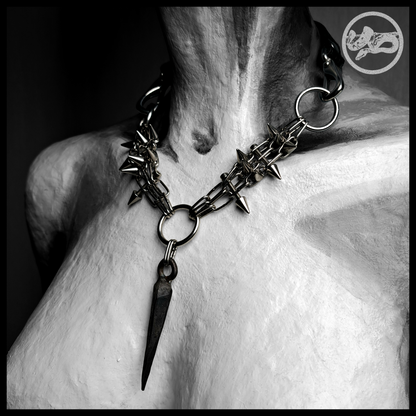 SARGNAGEL spiked chain necklace worn, front view, black and white: a V of fine stainless chain bristling with cone spikes, the forged coffin nail hanging from the centre ring. Handmade by skinpressedtight