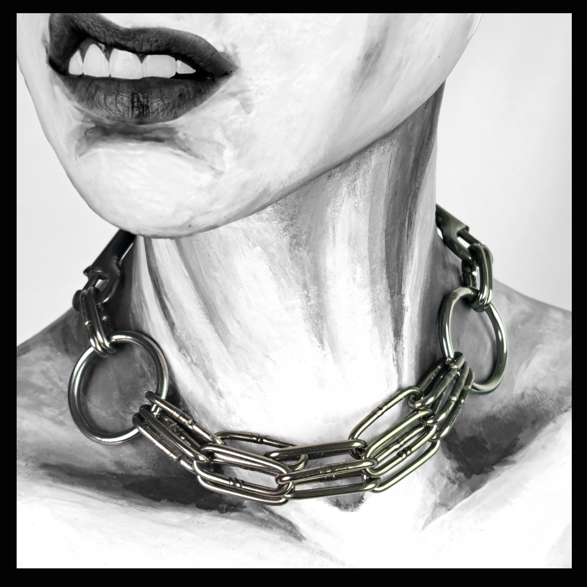 WARNSCHUSS chain necklace worn on a painted mannequin, black and white: three strands of heavy long-link stainless chain between two large O-rings, sitting loosely at the base of the neck. Handmade by skinpressedtight