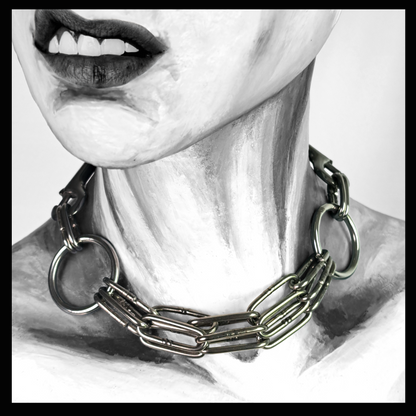 WARNSCHUSS chain necklace worn on a painted mannequin, black and white: three strands of heavy long-link stainless chain between two large O-rings, sitting loosely at the base of the neck. Handmade by skinpressedtight